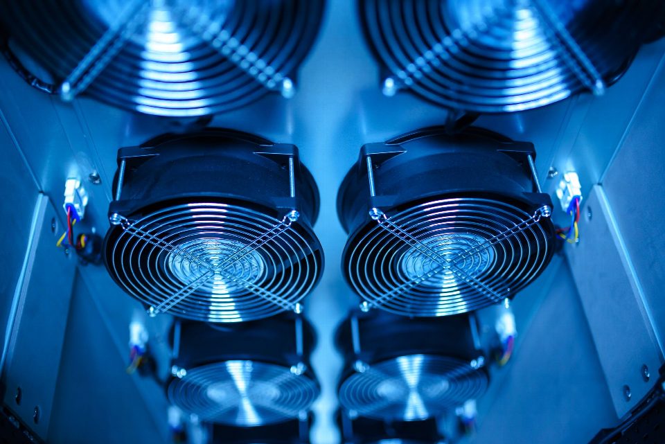 Close-up of cooling fans in a server room, showcasing technology and efficiency.