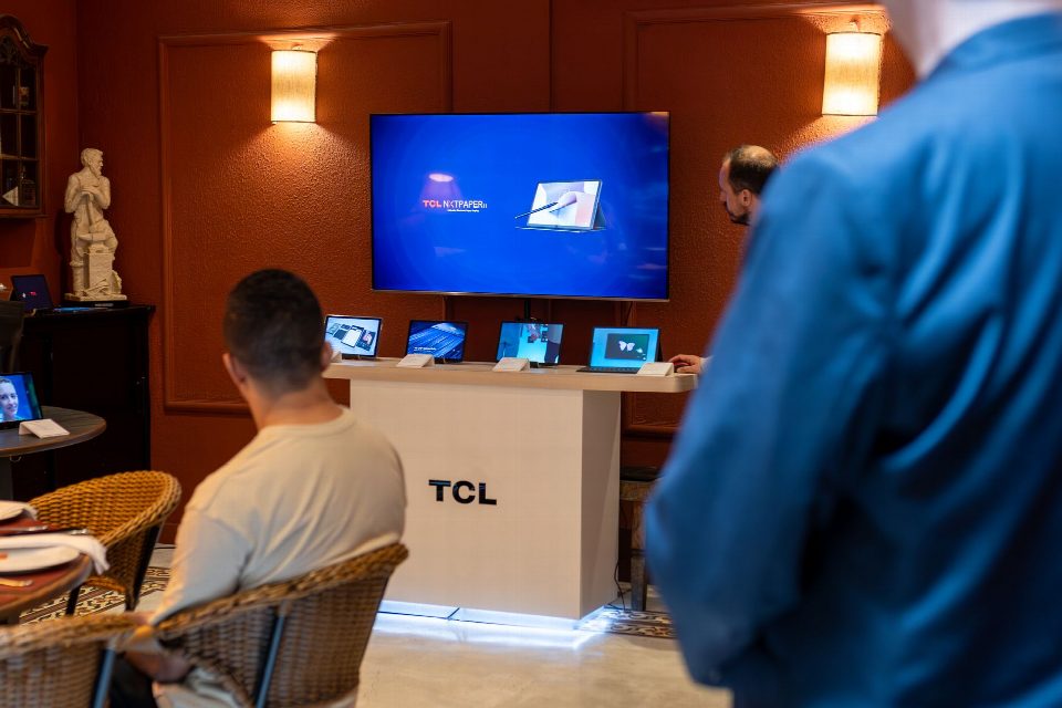 A professional business presentation showcasing new, sleek tablets and technology in a modern showroom setting. A professional business presentation showcasing new, sleek tablets and technology in a modern showroom setting.