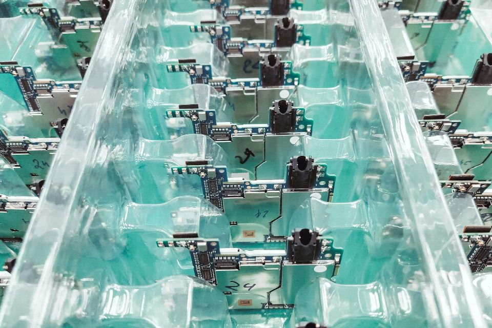 Detailed view of organized electronic circuit boards in a production setting. Detailed view of organized electronic circuit boards in a production setting.